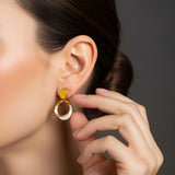 Close-up of Hermin’s Solara earrings featuring gold vermeil, natural chalcedony, and high-gloss enamel