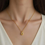 Close-up of Hermin's Gold Teardrop Pendant Necklace - Droplet in 18k gold vermeil over sterling silver, crafted for elegance and durability