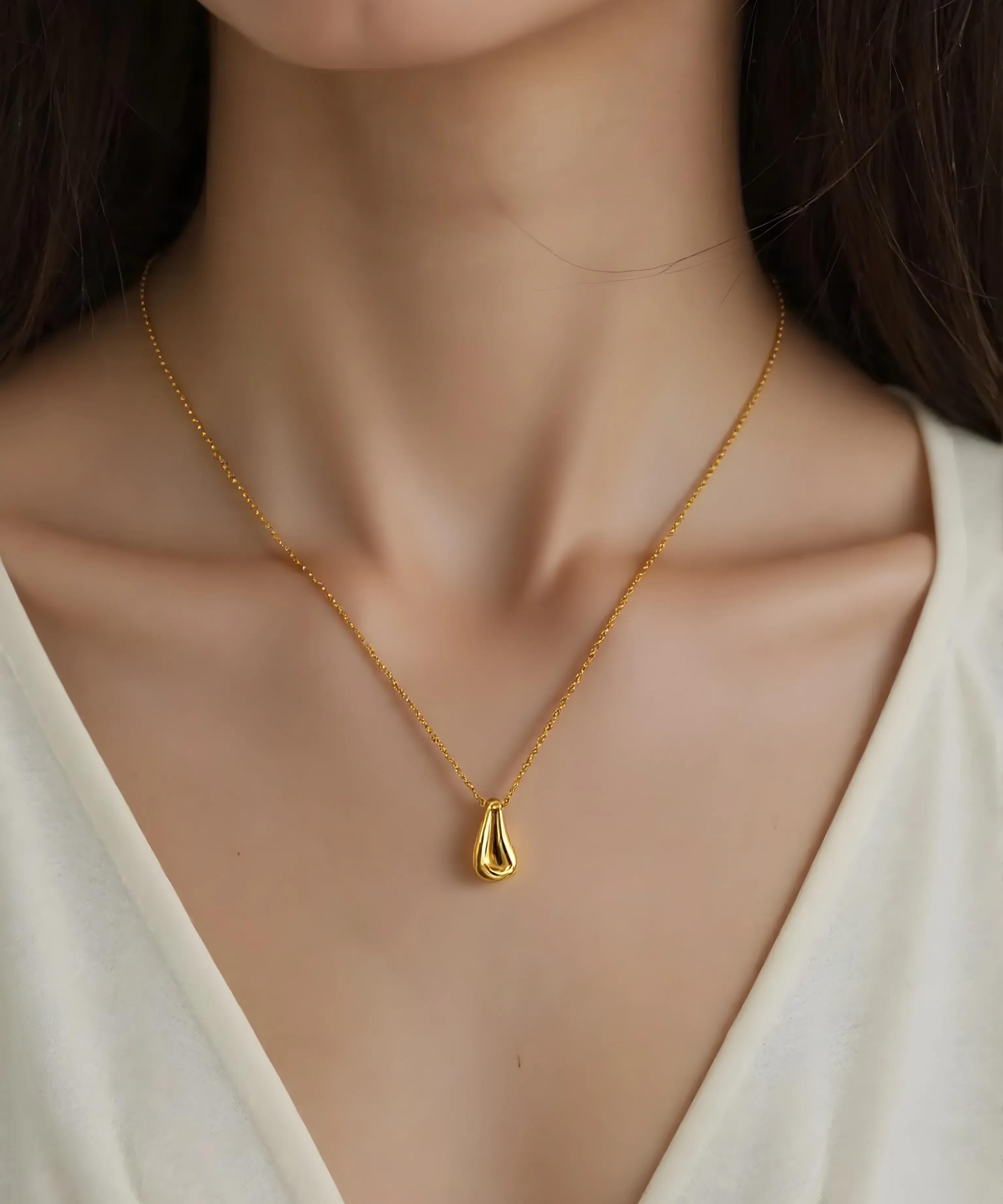 Close-up of Hermin's Gold Teardrop Pendant Necklace - Droplet in 18k gold vermeil over sterling silver, crafted for elegance and durability