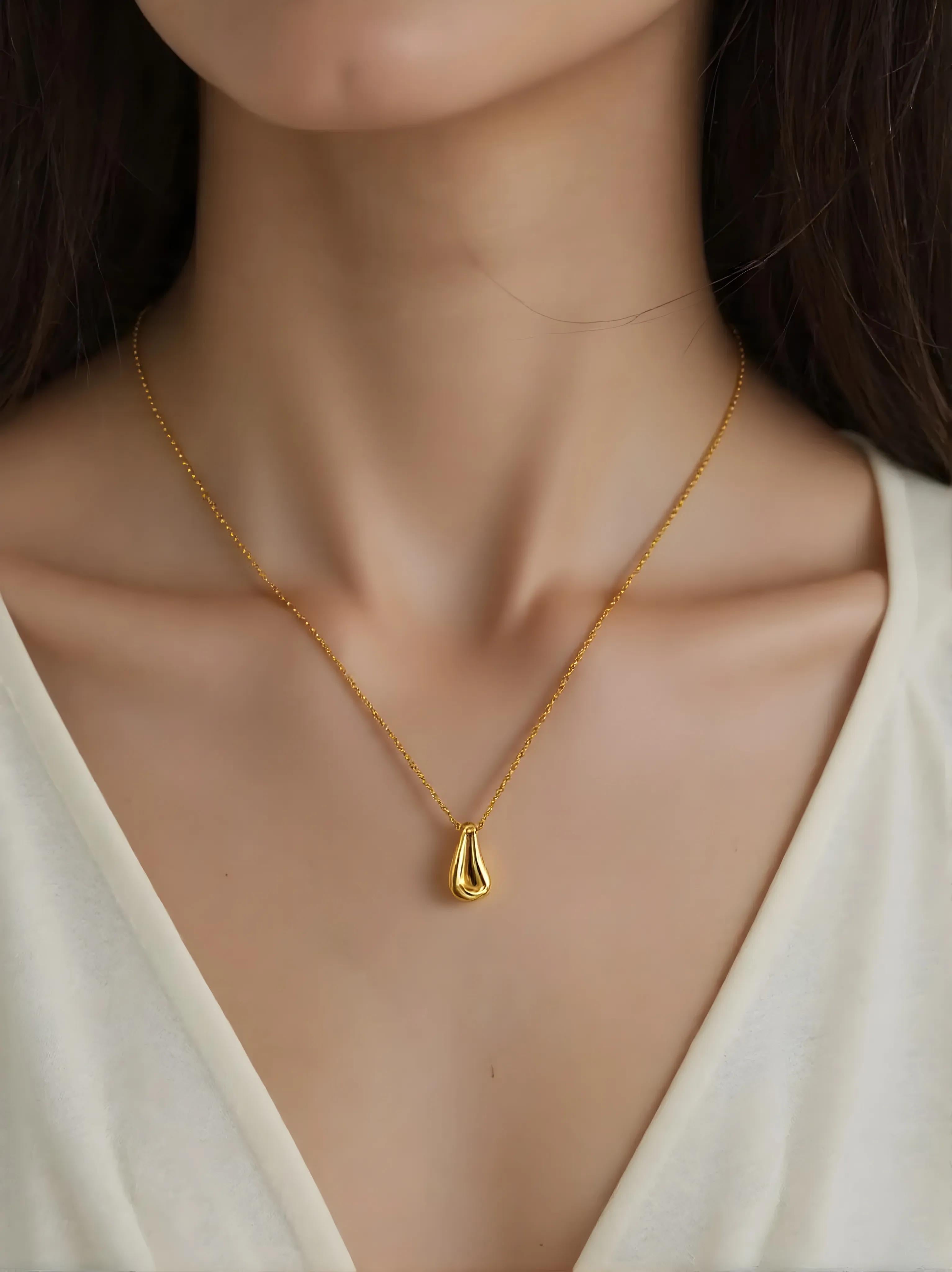 Close-up of Hermin's Gold Teardrop Pendant Necklace - Droplet in 18k gold vermeil over sterling silver, crafted for elegance and durability