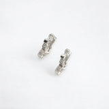 Petite geometric huggie hoops in sterling silver finish with pavé crystals