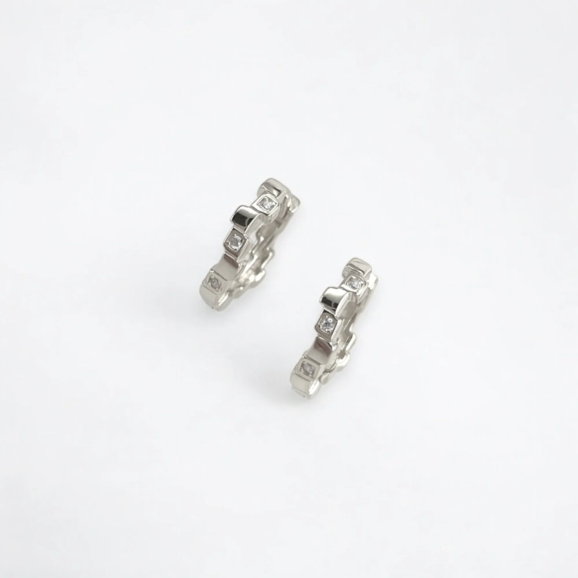 Petite geometric huggie hoops in sterling silver finish with pavé crystals