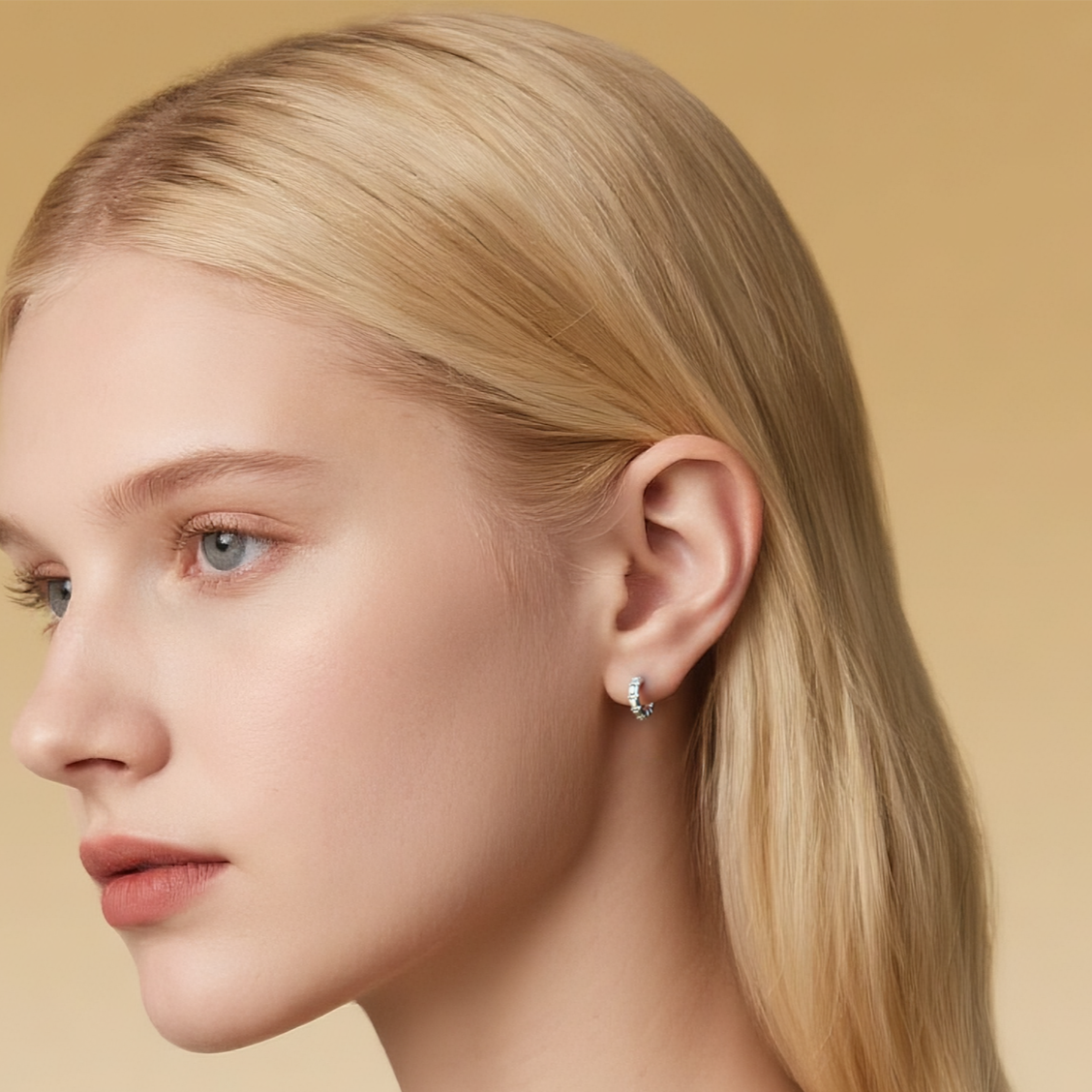 Close-up of Hermin's Tapered Baguette Silver Huggie Hoops in sterling silver with rhodium finish, crafted for elegance and durability