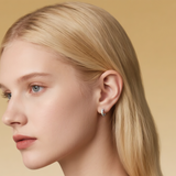 Close-up of Hermin's Tapered Baguette Silver Huggie Hoops in sterling silver with rhodium finish, crafted for elegance and durability