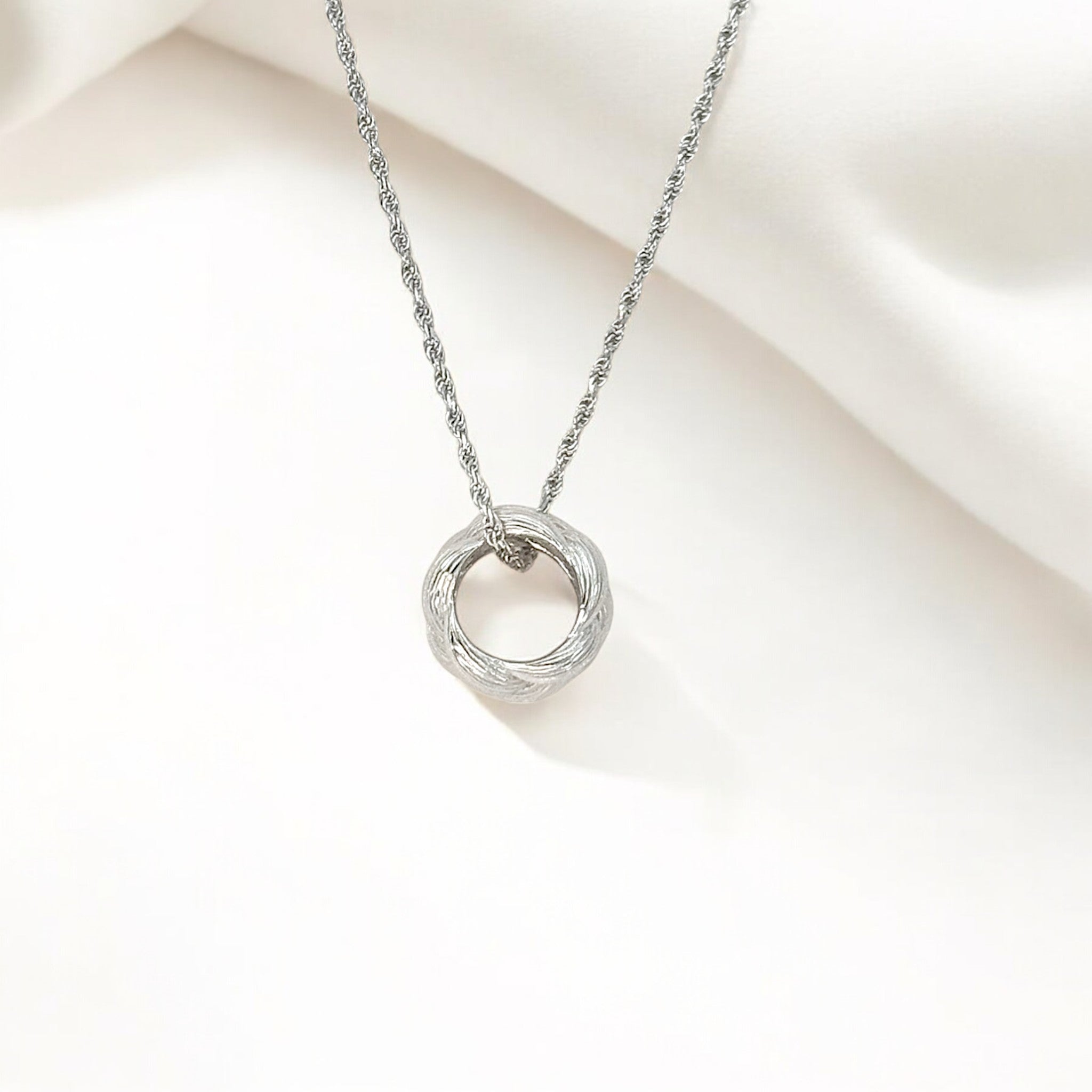 Close-up of Hermin's Tulle Textured Silver Woven Pendant Necklace - Twill in sterling silver with rhodium finish, crafted for elegance and durability