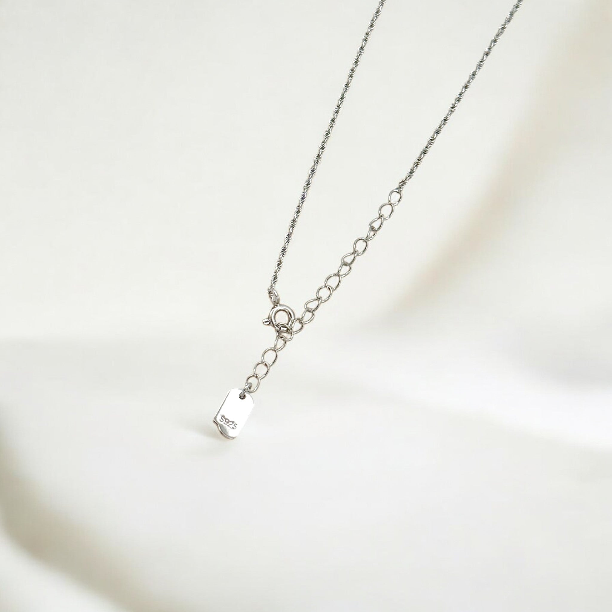 Close-up of Hermin's Tulle Textured Silver Woven Pendant Necklace - Twill in sterling silver with rhodium finish, crafted for elegance and durability