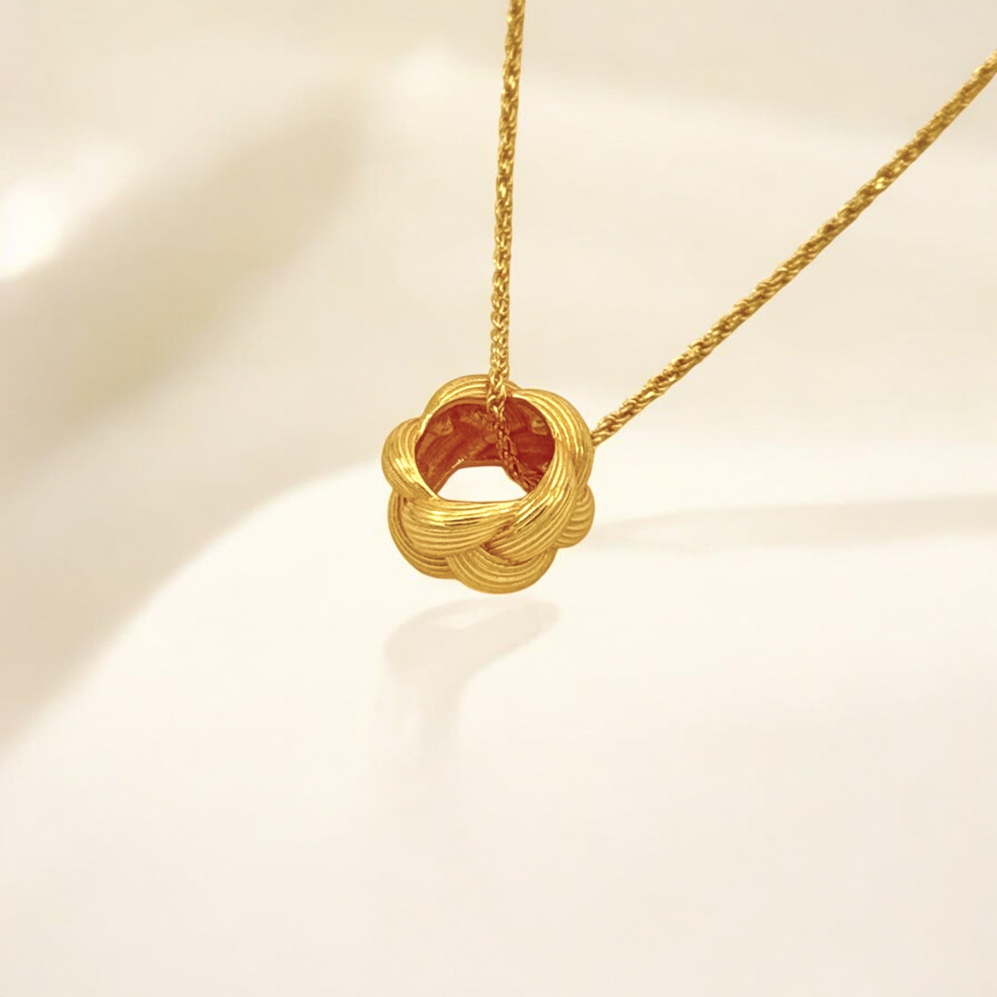 Close-up of Hermin's Tulle Textured Gold Woven Pendant Necklace - Twill in 18k gold vermeil over sterling silver, crafted for elegance and durability