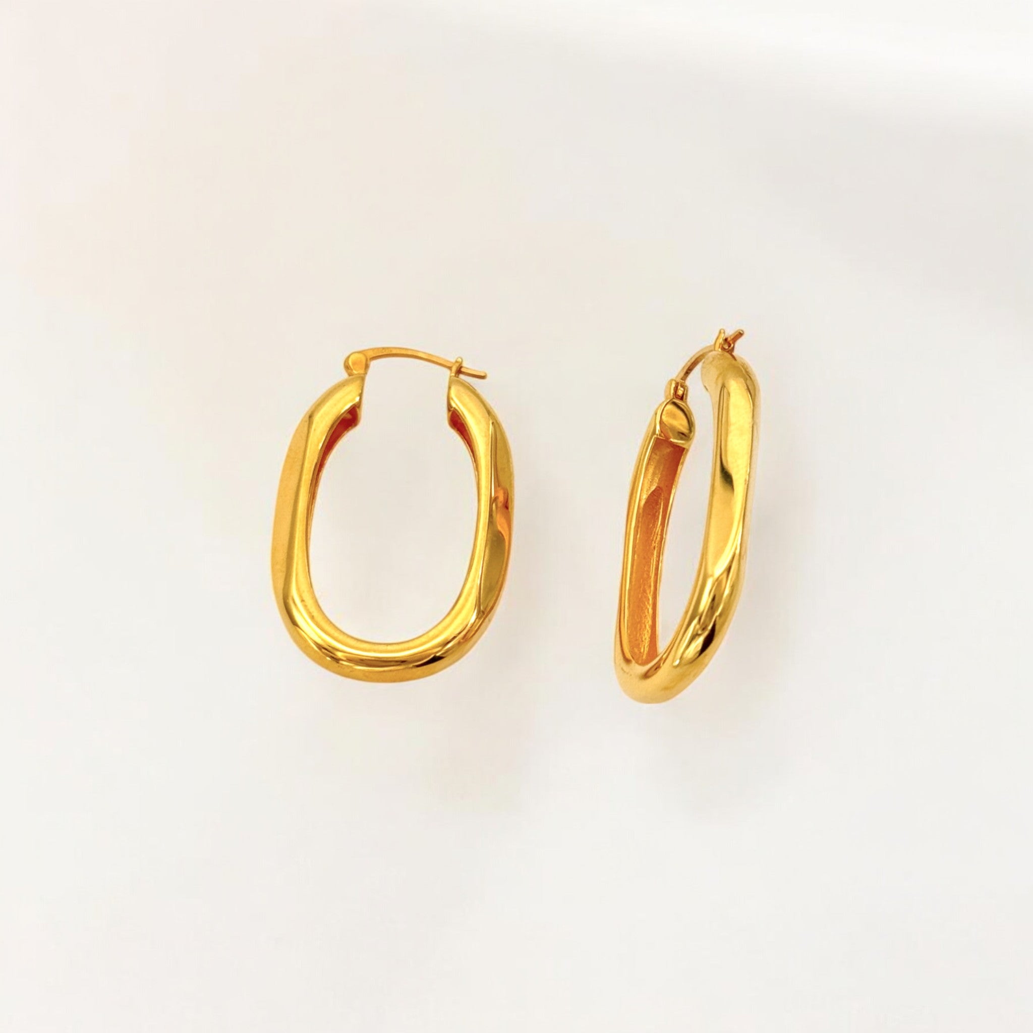 Close-up of Hermin's Classic Statement Oval Gold Hoops - Milan in 18k gold vermeil over sterling silver, crafted for elegance and durability