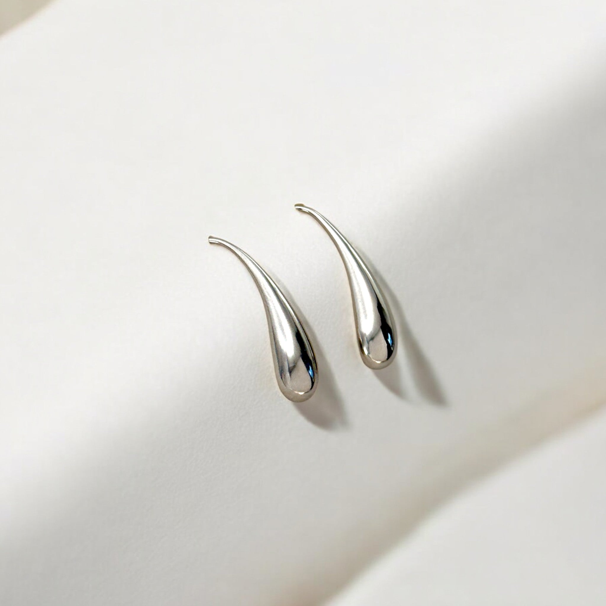 Close-up of Hermin's Silver Threader Teardrop Earrings - Droplet in sterling silver with rhodium finish, crafted for elegance and durability