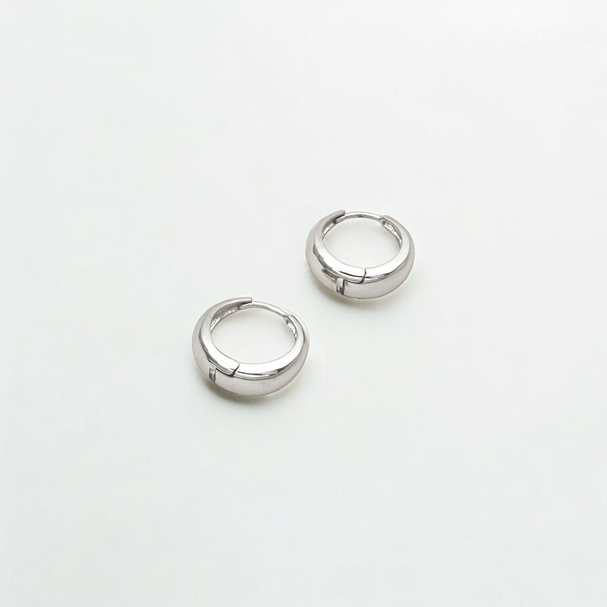Eclipse Silver Dome Huggie Hoops made from sterling silver with rhodium finish, minimalist design by Hermin Jewelry