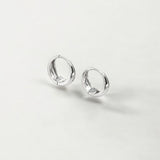 Eclipse Silver Dome Huggie Hoops made from sterling silver with rhodium finish, minimalist design by Hermin Jewelry