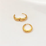 Close-up of Hermin's Eclipse Gold Dome Huggie Hoops in 18k gold vermeil over sterling silver, crafted for elegance and durability