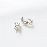 Close-up of Hermin's Everyday Silver Twist Huggies - Paris in sterling silver with rhodium finish, crafted for elegance and durability