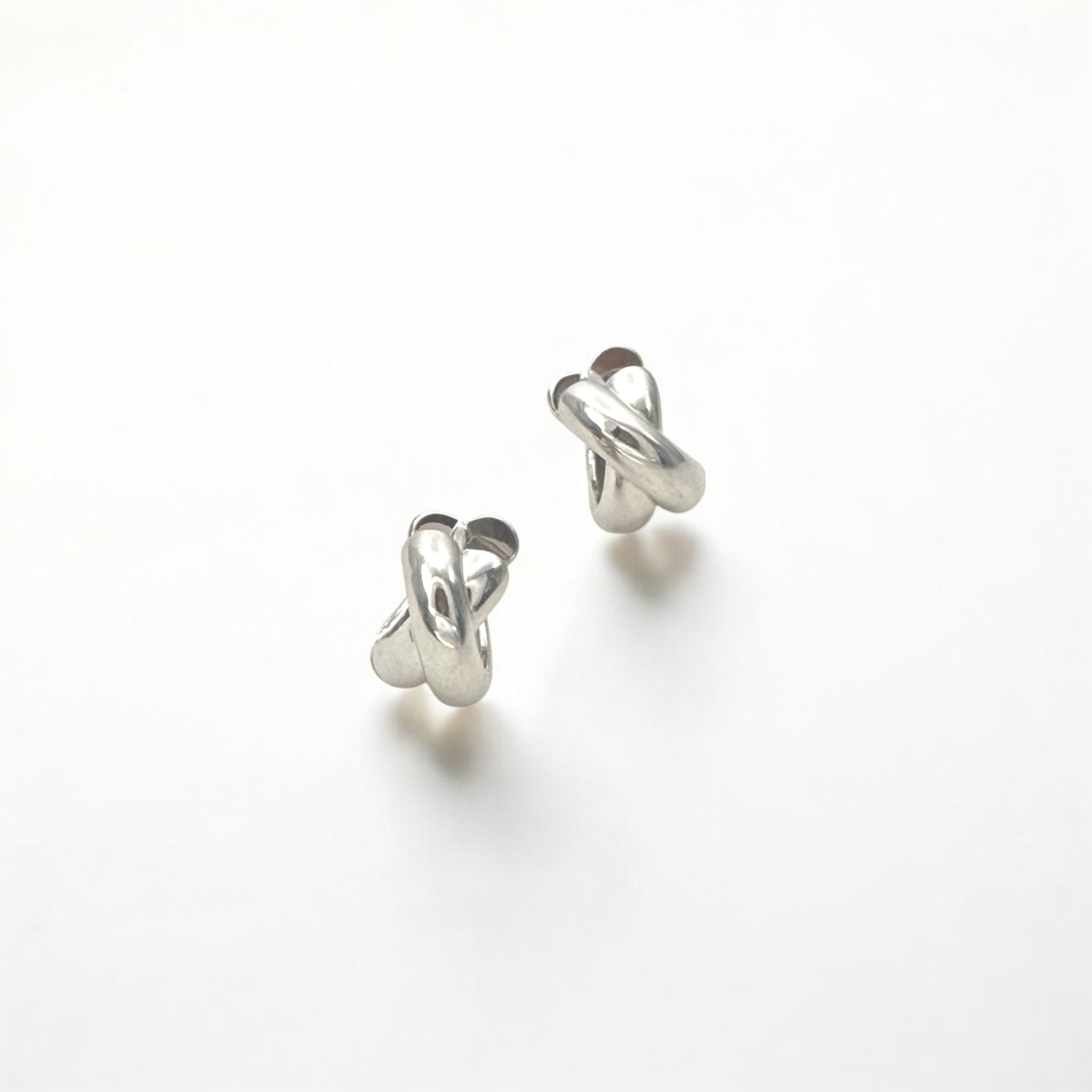 Everyday Silver Twist Huggies - Paris made from sterling silver with rhodium finish, minimalist design by Hermin Jewelry