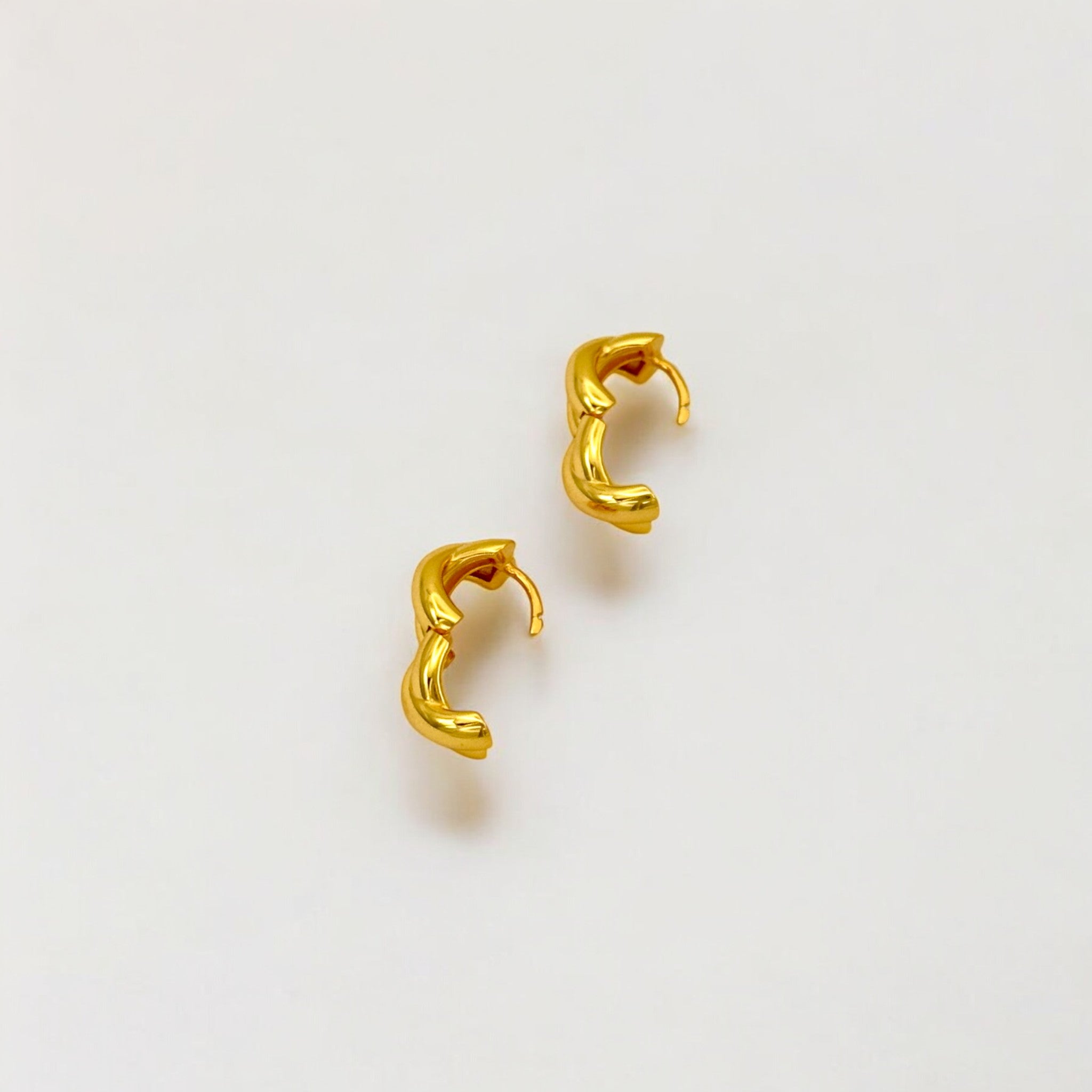 Close-up of Hermin's Everyday Gold Twist Huggies - Paris in 18k gold vermeil over sterling silver, crafted for elegance and durability