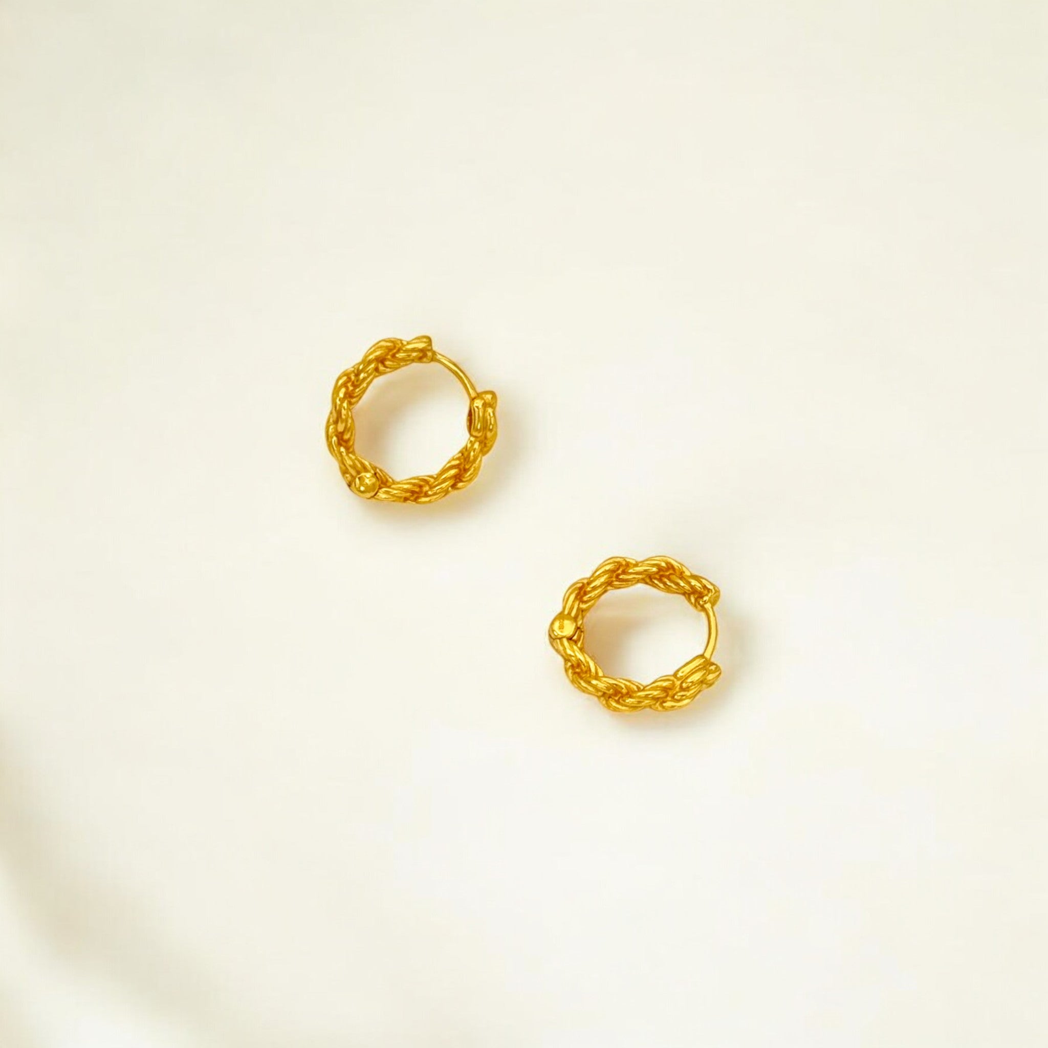 Close-up of Hermin's Braided Gold Huggie Hoops - Paris in 18k gold vermeil over sterling silver, crafted for elegance and durability