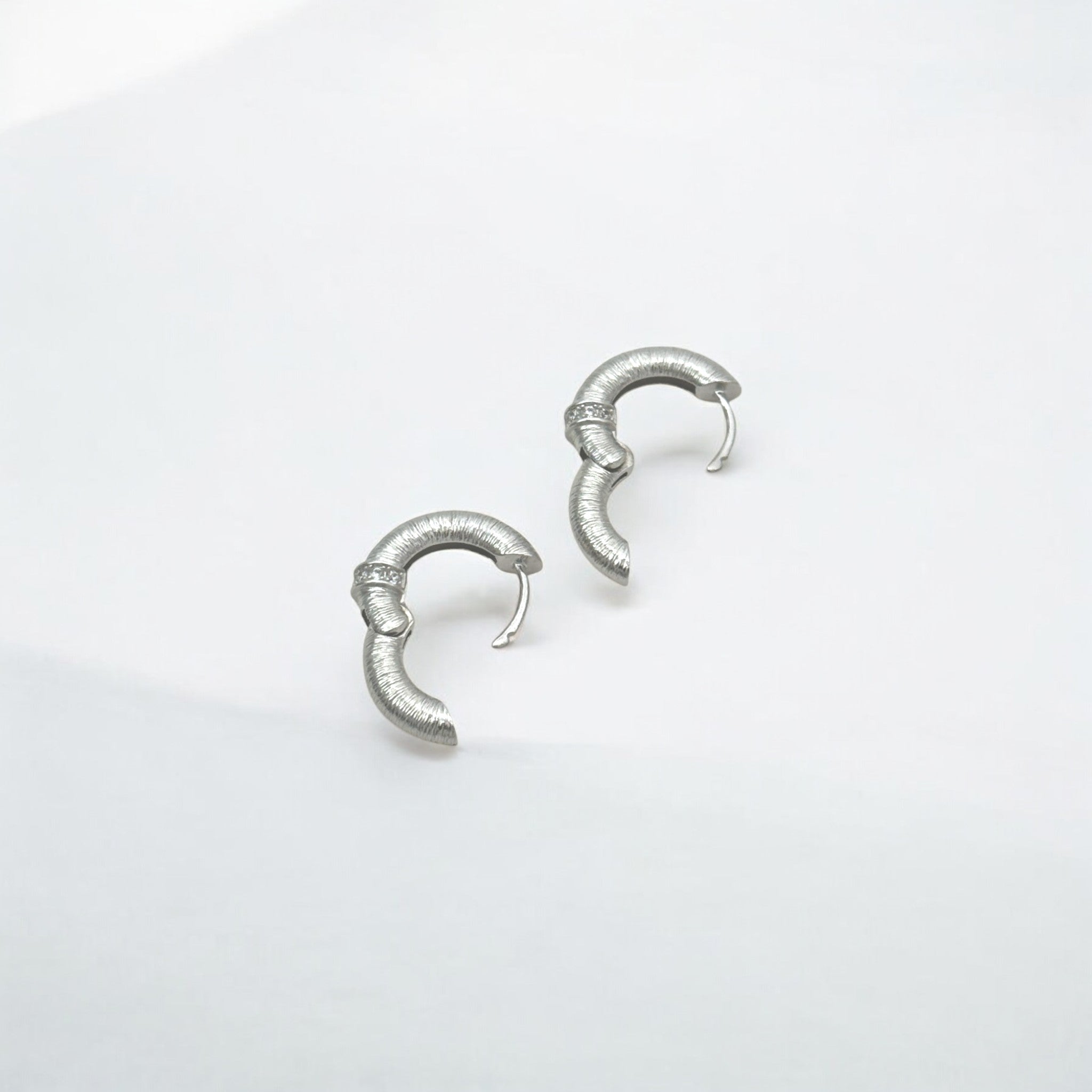 Close-up of Hermin's Tulle Silver Sparkle Everyday Hoops in sterling silver with rhodium finish, crafted for elegance and durability