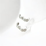 Close-up of Hermin's Tulle Textured Silver Woven Sparkle Huggie Hoops in sterling silver with rhodium finish, crafted for elegance and durability