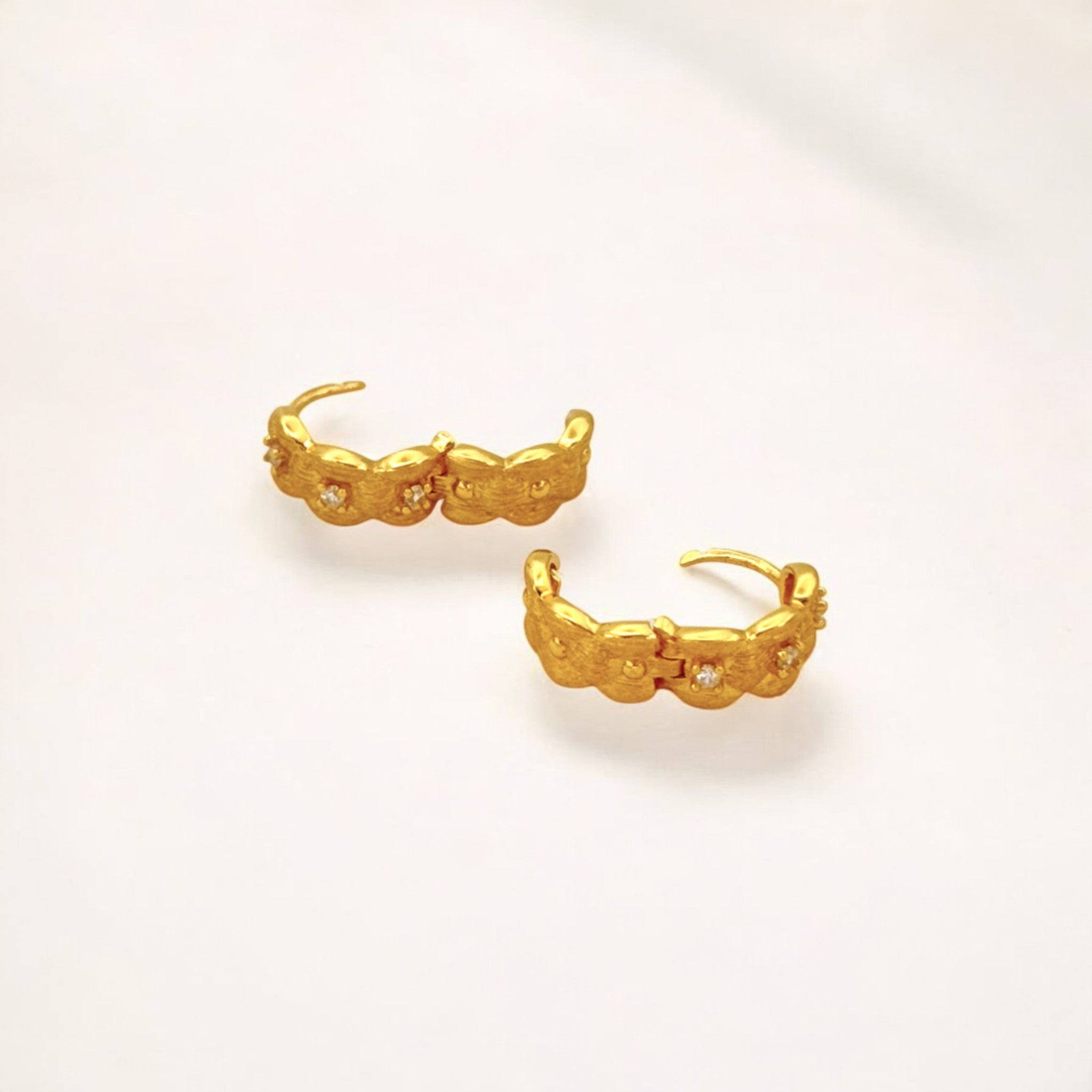 Close-up of Hermin's Tulle Textured Gold Woven Sparkle Huggie Hoops in 18k gold vermeil over sterling silver, crafted for elegance and durability