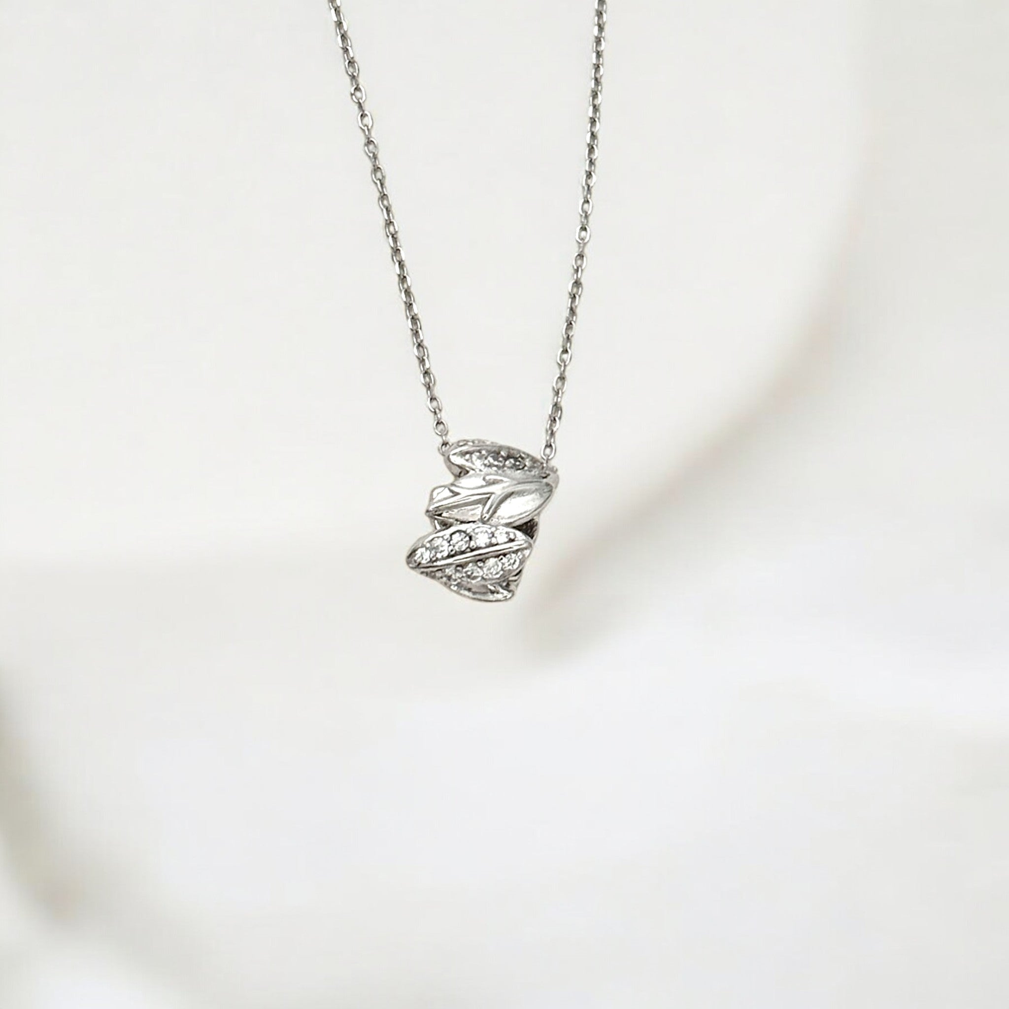 Close-up of Hermin's Silver Sparkle Leaf Pendant Necklace - Olivia in sterling silver with rhodium finish, crafted for elegance and durability