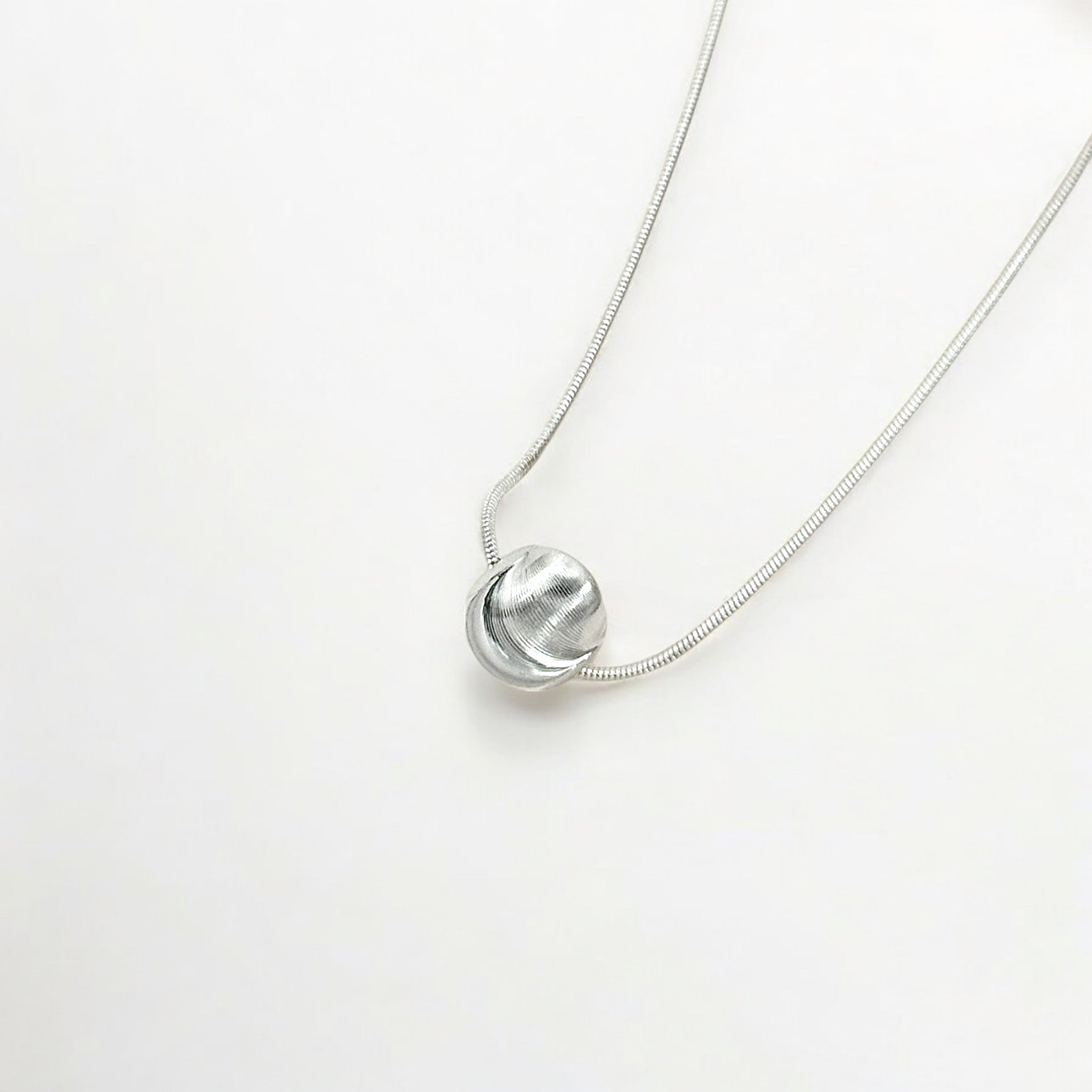 Close-up of Hermin's Tulle Textured Orb Necklace - Mercury in 18k gold vermeil or sterling silver, crafted for elegance and durability