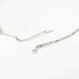 Close-up of Hermin's Faceted Silver Bead Necklace - Gleam in sterling silver with rhodium finish, crafted for elegance and durability