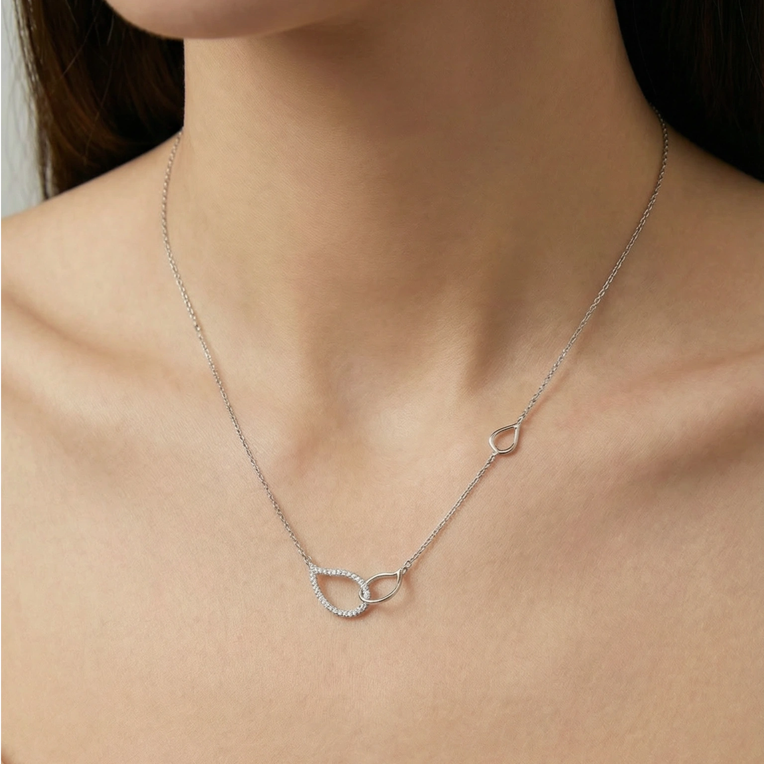 Elegant pavé interlocking circle pendant necklace in polished silver with shimmering crystal accents