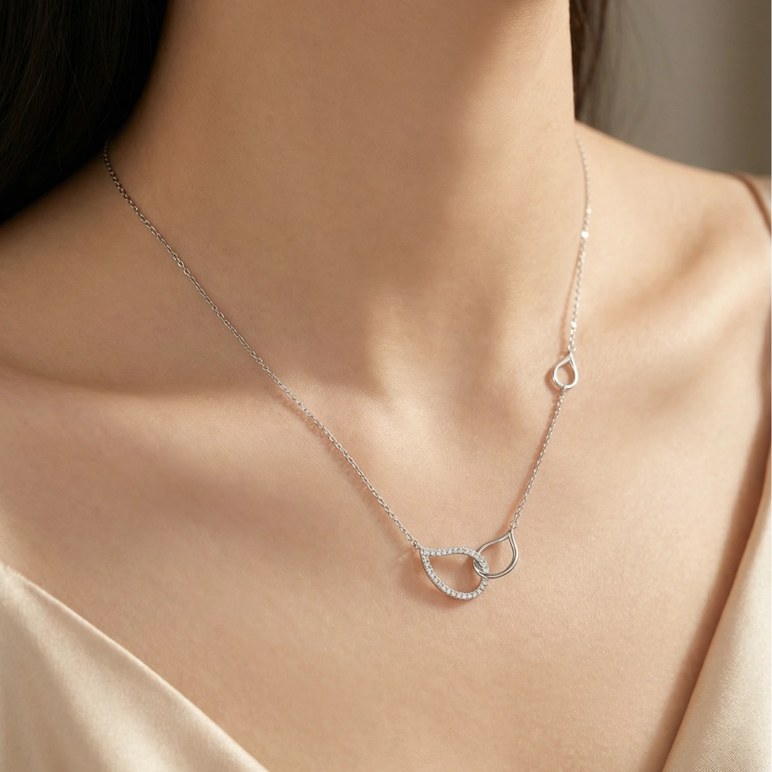 Sterling silver interlocking circle necklace with pavé crystals on delicate chain, symbolizing eternal connection.