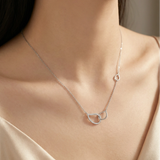 Sterling silver interlocking circle necklace with pavé crystals on delicate chain, symbolizing eternal connection.
