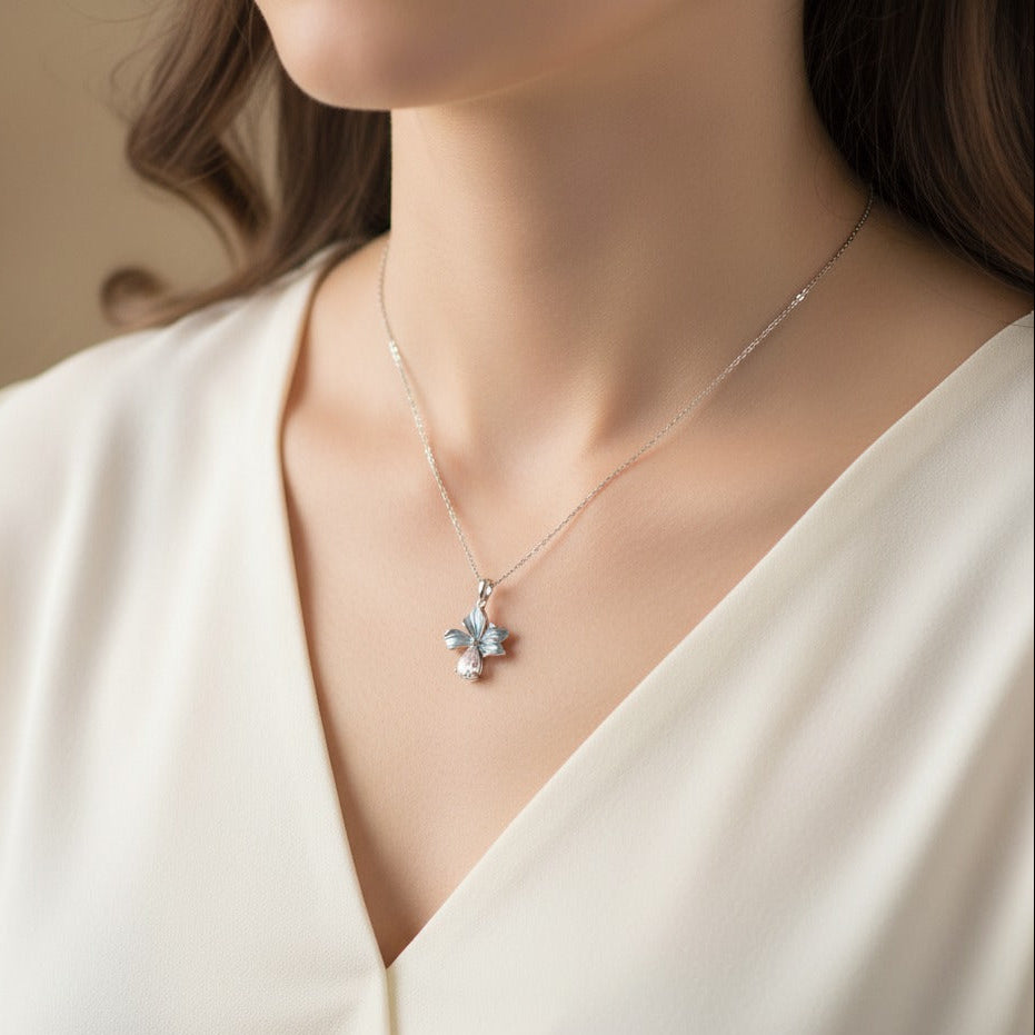 Model wearing sterling silver blue enamel bloom flower pendant necklace