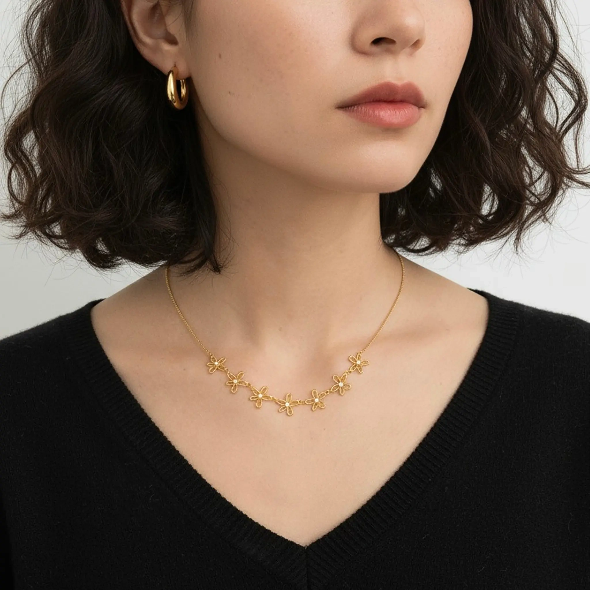 Model wearing gold petite sparkle chain necklace at collarbone
