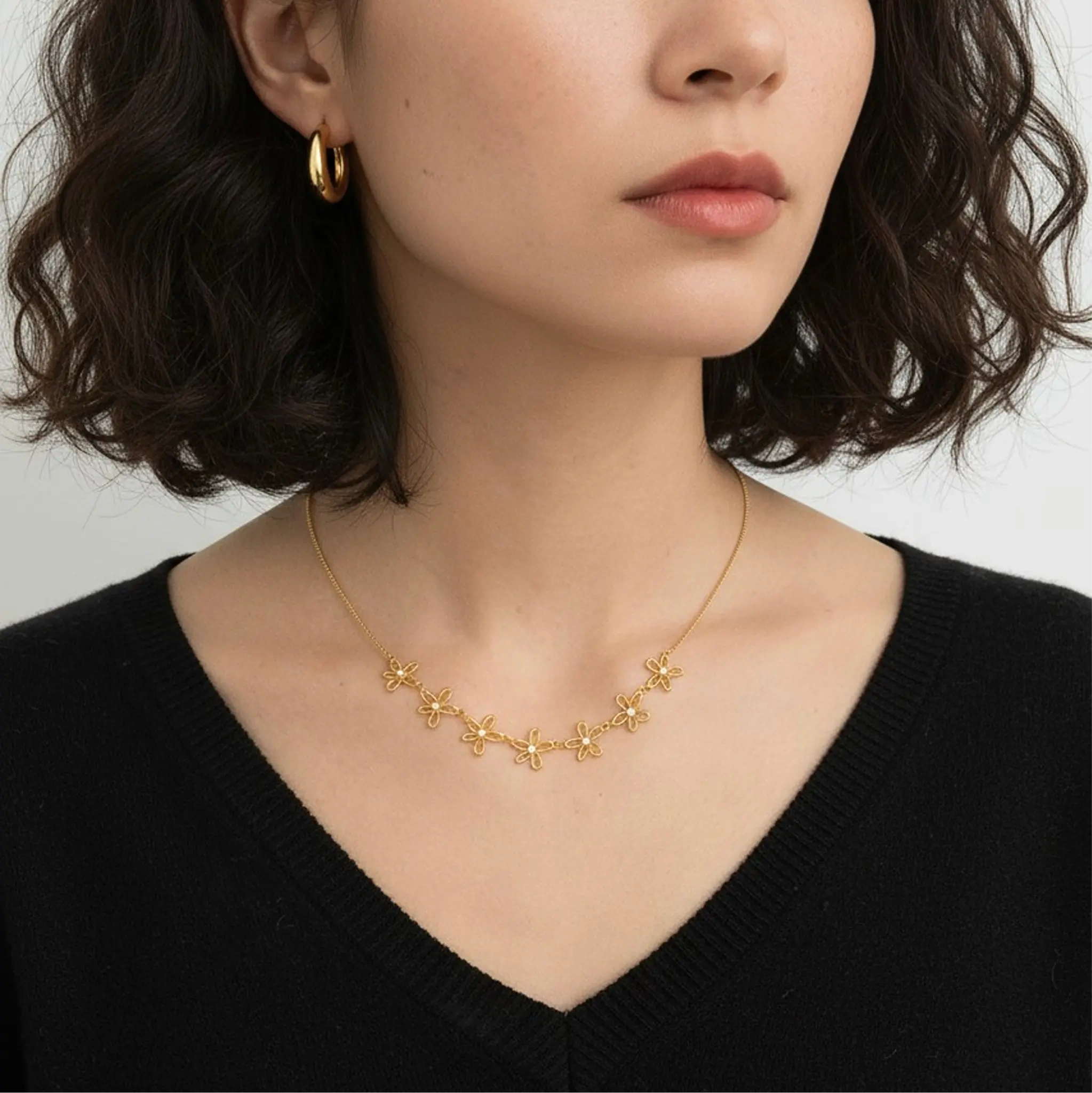 Model wearing gold petite sparkle chain necklace at collarbone
