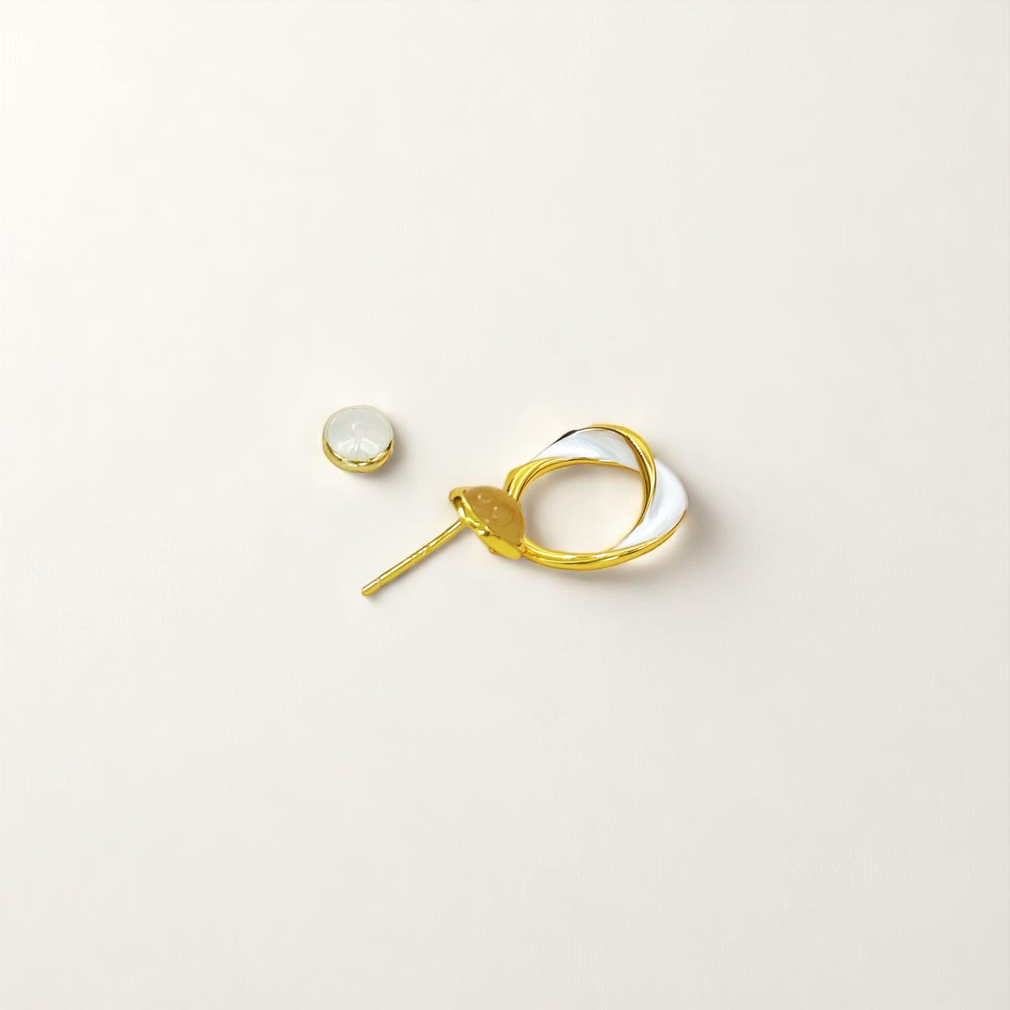 Close-up of Hermin’s Solara earrings featuring gold vermeil, natural chalcedony, and high-gloss enamel