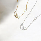 Pavé interlocking silver circle necklace on white background