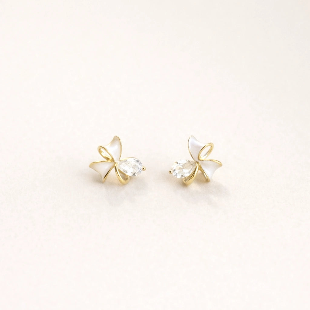 Gold mini bow stud earrings for women with white enamel and crystal accents