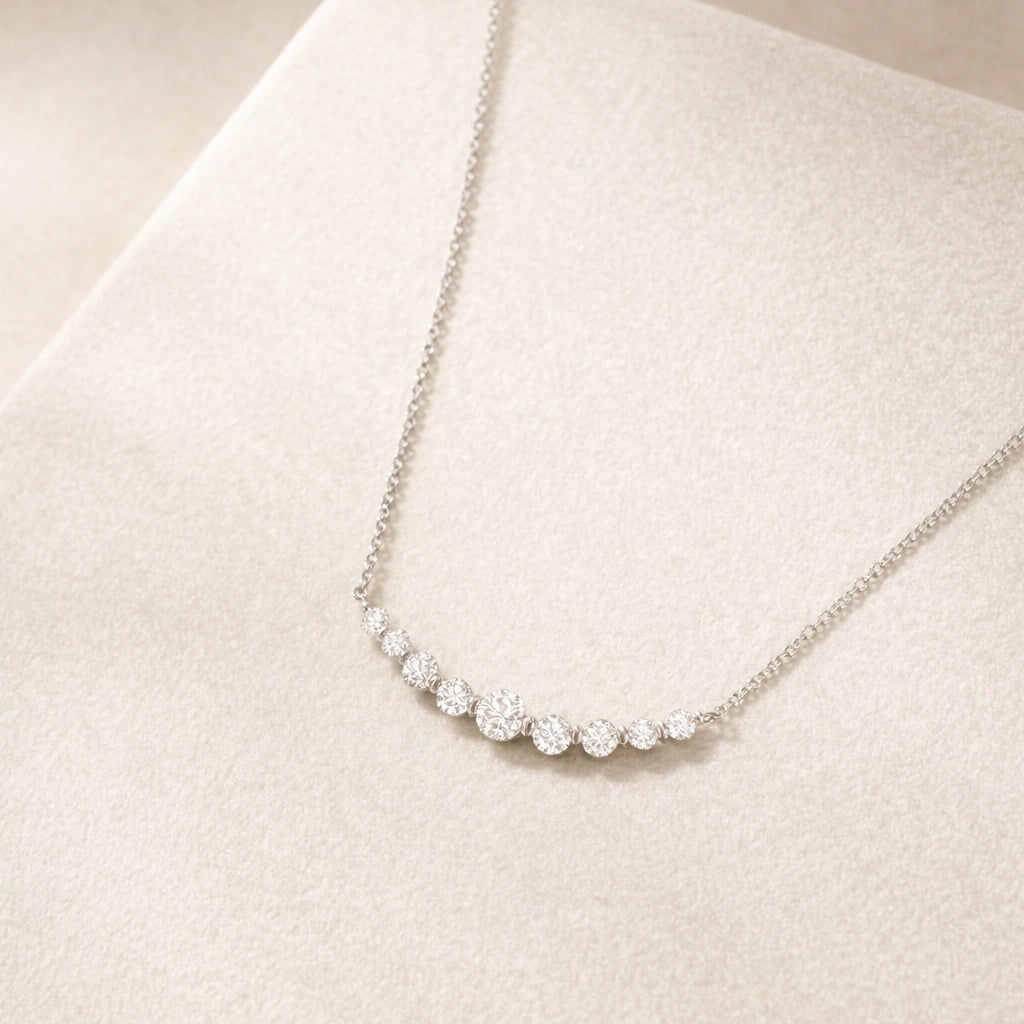 Sterling silver crescent bar necklace for women with graduated moissanite stones
