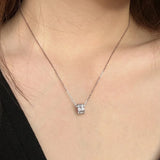 Model wearing sterling silver moissanite solitaire pendant necklace at collarbone