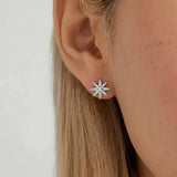 Model wearing hypoallergenic sterling silver north star stud earrings with rhodium vermeil
