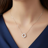 Model wearing sterling silver moissanite circle pendant necklace with crown design