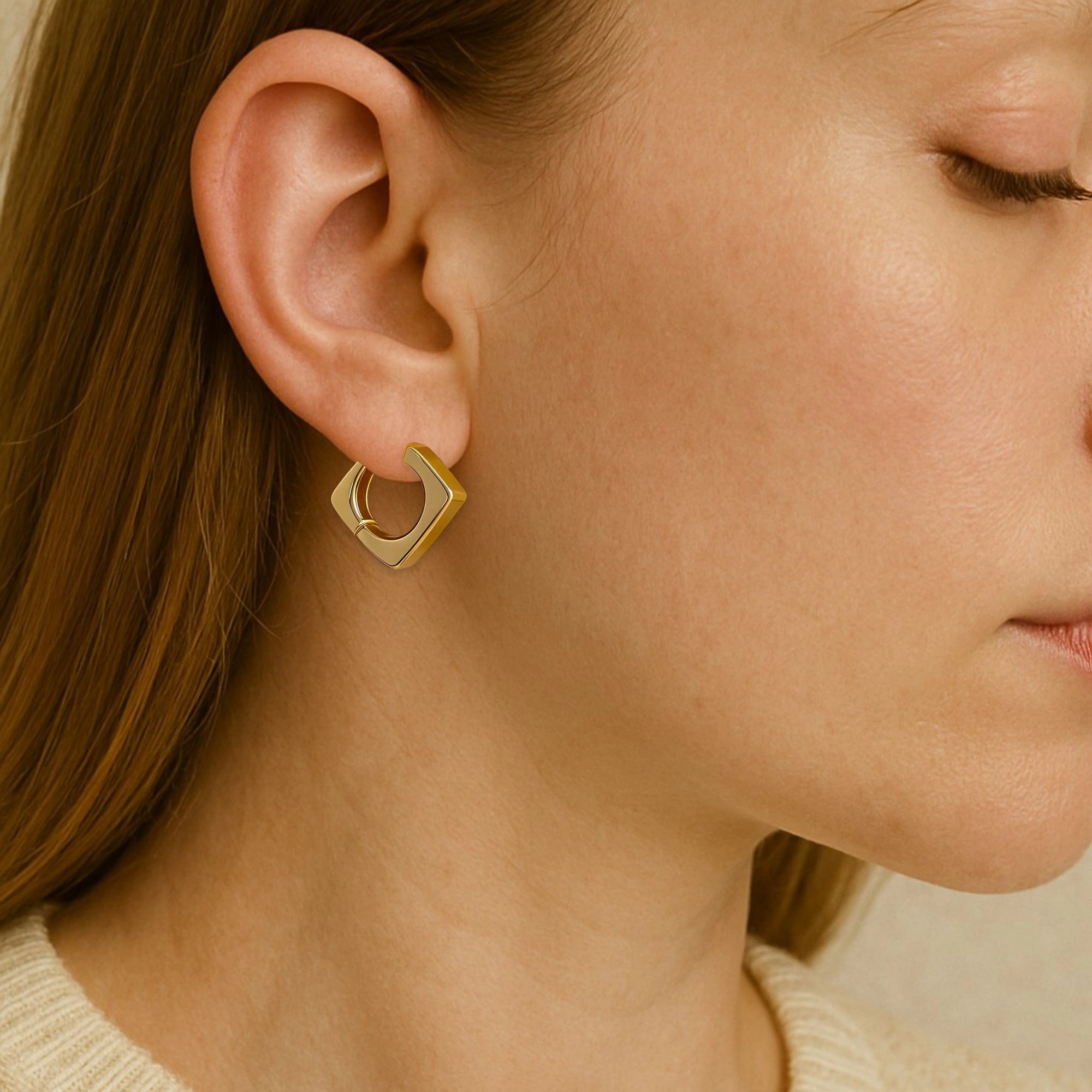 Model wearing hypoallergenic gold vermeil squared hoop earrings
