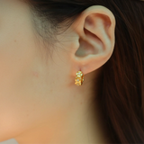 Model wearing hypoallergenic gold vermeil tulle textured woven sparkle huggie hoop earrings
