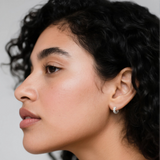 Model wearing hypoallergenic rhodium vermeil tulle textured woven sparkle huggie hoop earrings
