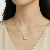 Feminine white enamel bow necklace in gold, perfect for layering or wearing alone as a dainty accent piece