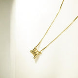 Close-up of Hermin's Torque Knot Gold Necklace in 18k gold vermeil over sterling silver, crafted for elegance and durability