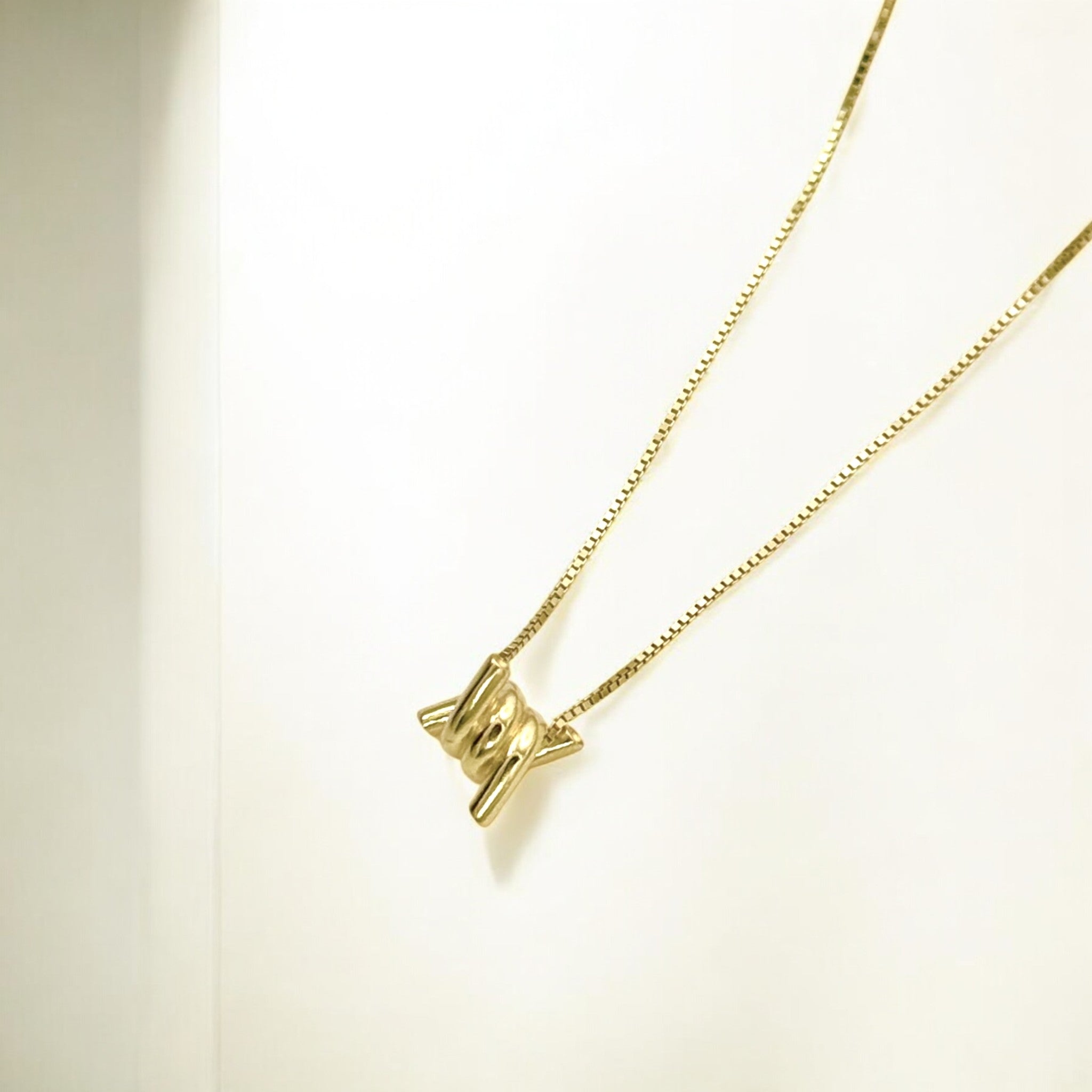 Close-up of Hermin's Torque Knot Gold Necklace in 18k gold vermeil over sterling silver, crafted for elegance and durability