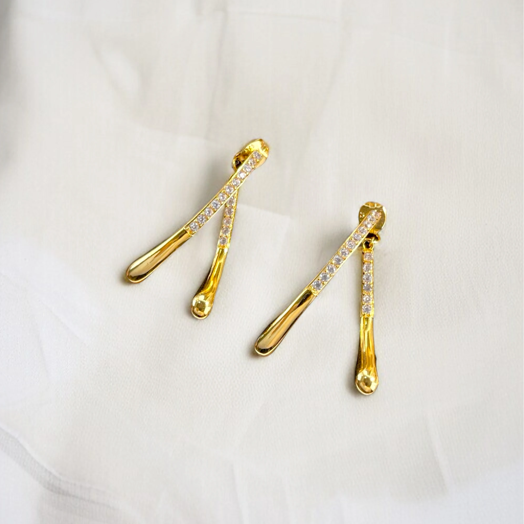 Macro close-up of CZ pavé setting on Aurelia gold vermeil drop earrings, highlighting sparkle and polished finish