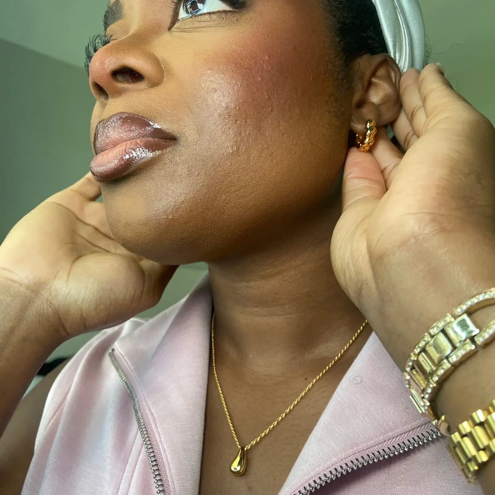 Woman wearing an earring with a gold necklace with elegant and quiet luxury style for church, daily office, classic look