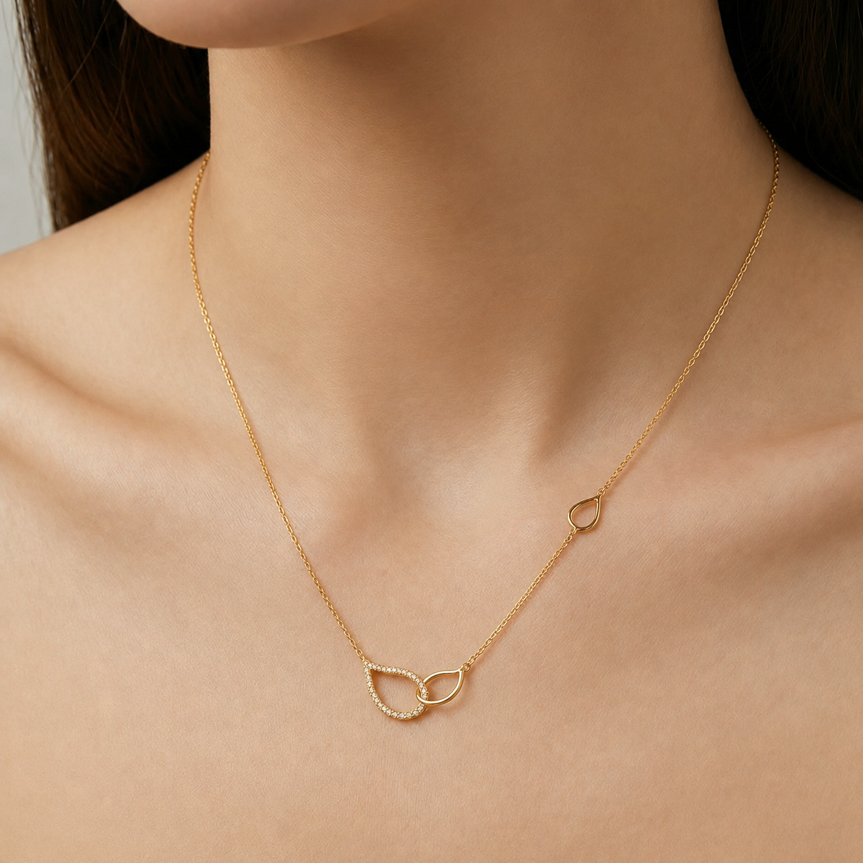 Gold necklace with a cat-shaped pendant on a person's neck