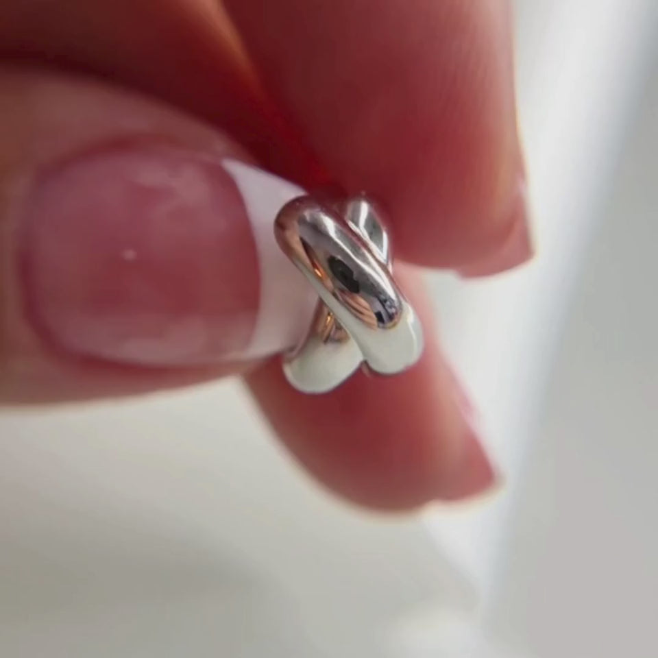 Hermin everyday silver twist huggies, Classic huggie earrings with a soft, twisted design. Crafted with rhodium vermeil sterling silver, these earrings seamlessly blend modern design with elegant curves, offering versatile, everyday chic styles. 